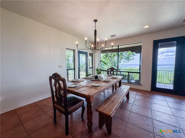 a bathroom with a granite countertop tub sink and mirror