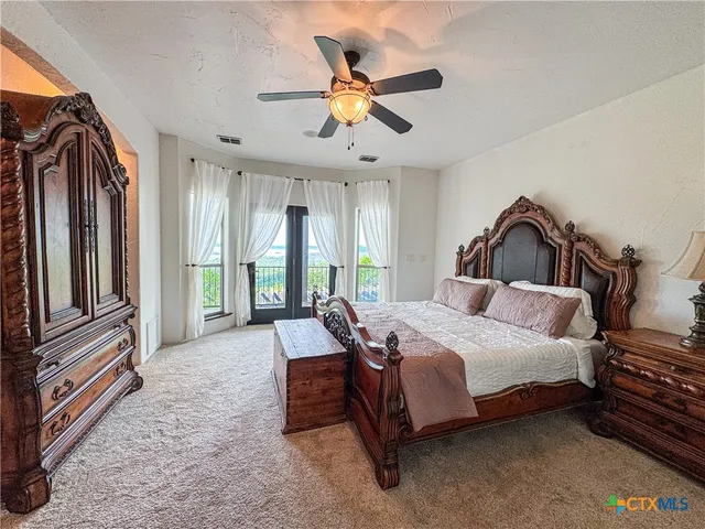 a bathroom with a granite countertop toilet and a sink