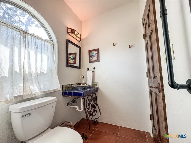 a view of staircase with lots of frames on wall and a window