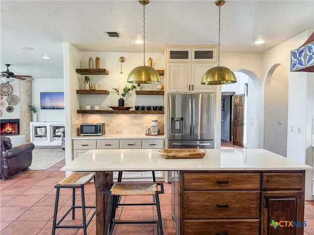 a large kitchen with a table and chairs