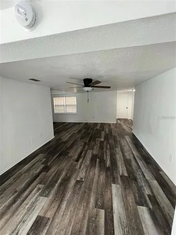 a view of a room with wooden floor