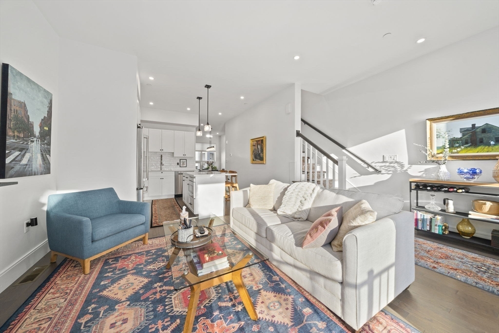 17-31 Charles Park Road, Unit 196 Boston, MA 02132 - Photo 2 of 25 a living room with furniture and a rug