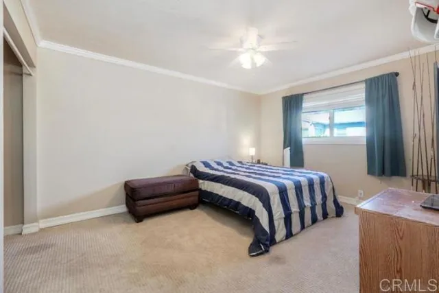 a spacious bedroom with a bed and a chandelier