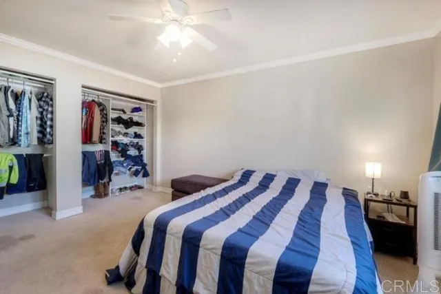 a bedroom with a bed and a view of closet