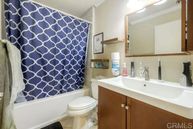 a bathroom with a sink a toilet a mirror and shower