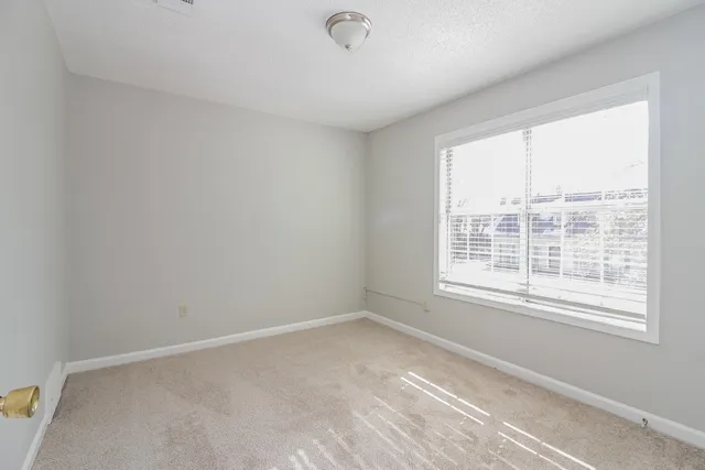 a bathroom with a sink a toilet and a window