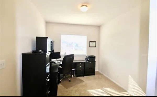 a workspace with furniture and window