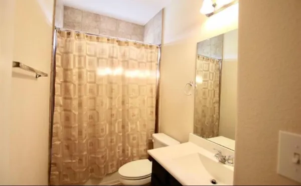 a bathroom with a toilet a sink and a shower