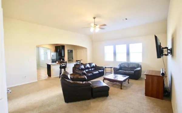 a living room with furniture and a chandelier