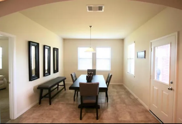 a dining room with furniture and window