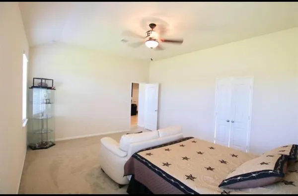 a bedroom with a bed and chandelier