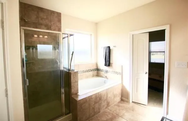 a bathroom with a tub and shower