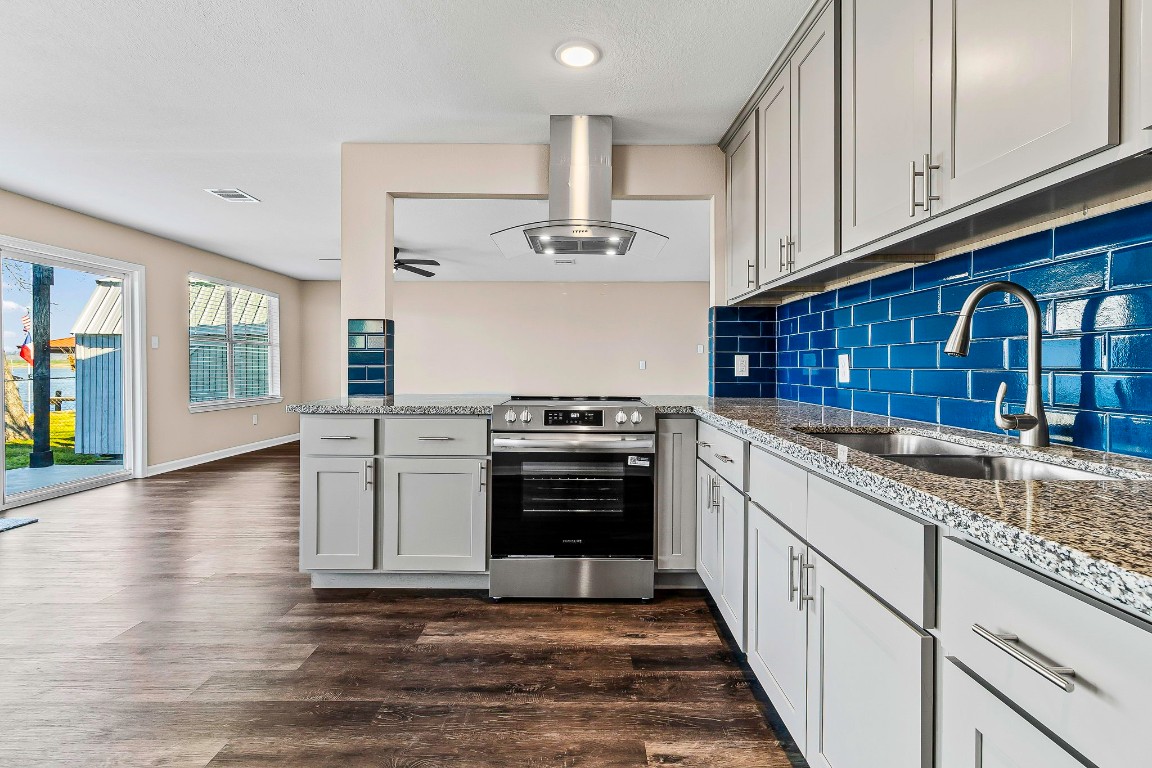 416 Kickapoo Drive Livingston, TX 77351 - Photo 12 of 36 a kitchen with stainless steel appliances granite countertop a stove and cabinets