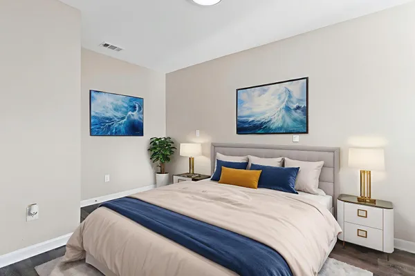 a bedroom with a bed and a painting on the wall