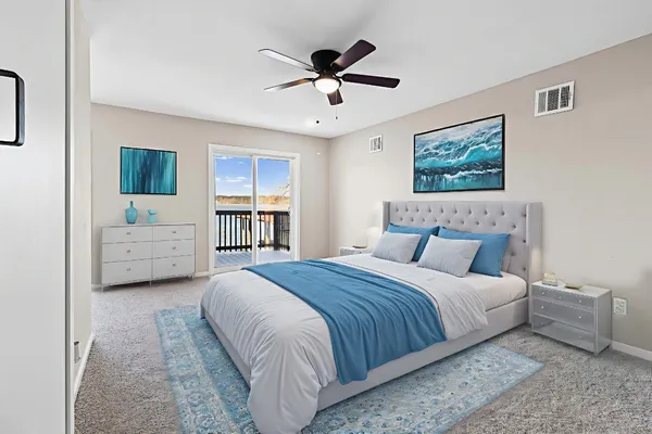 a spacious bedroom with a bed and a ceiling fan