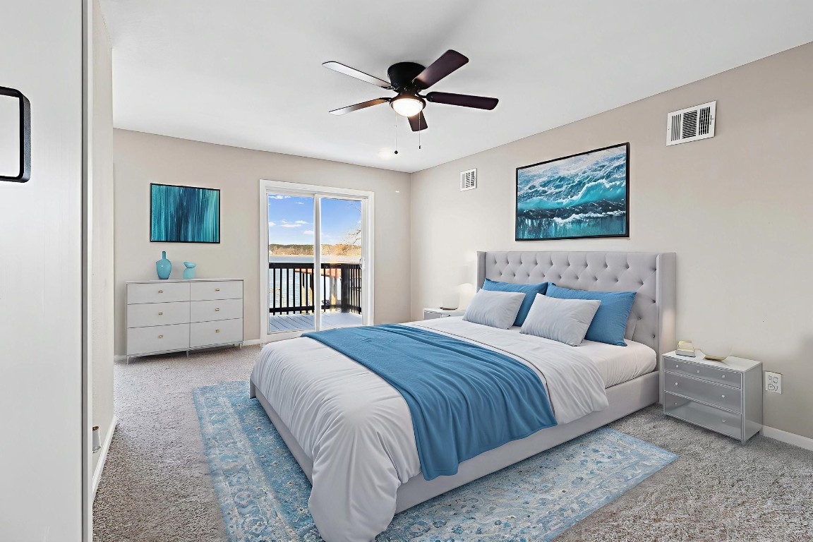 416 Kickapoo Drive Livingston, TX 77351 - Photo 22 of 36 a spacious bedroom with a bed and a ceiling fan