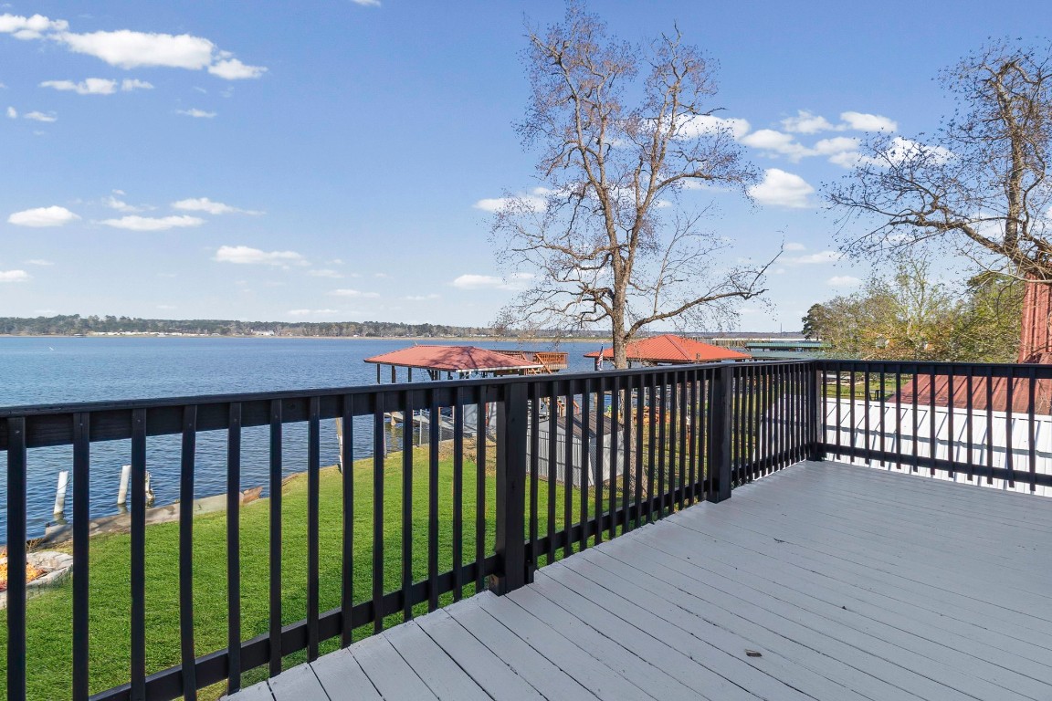 416 Kickapoo Drive Livingston, TX 77351 - Photo 28 of 36 a balcony with wooden floor and fence