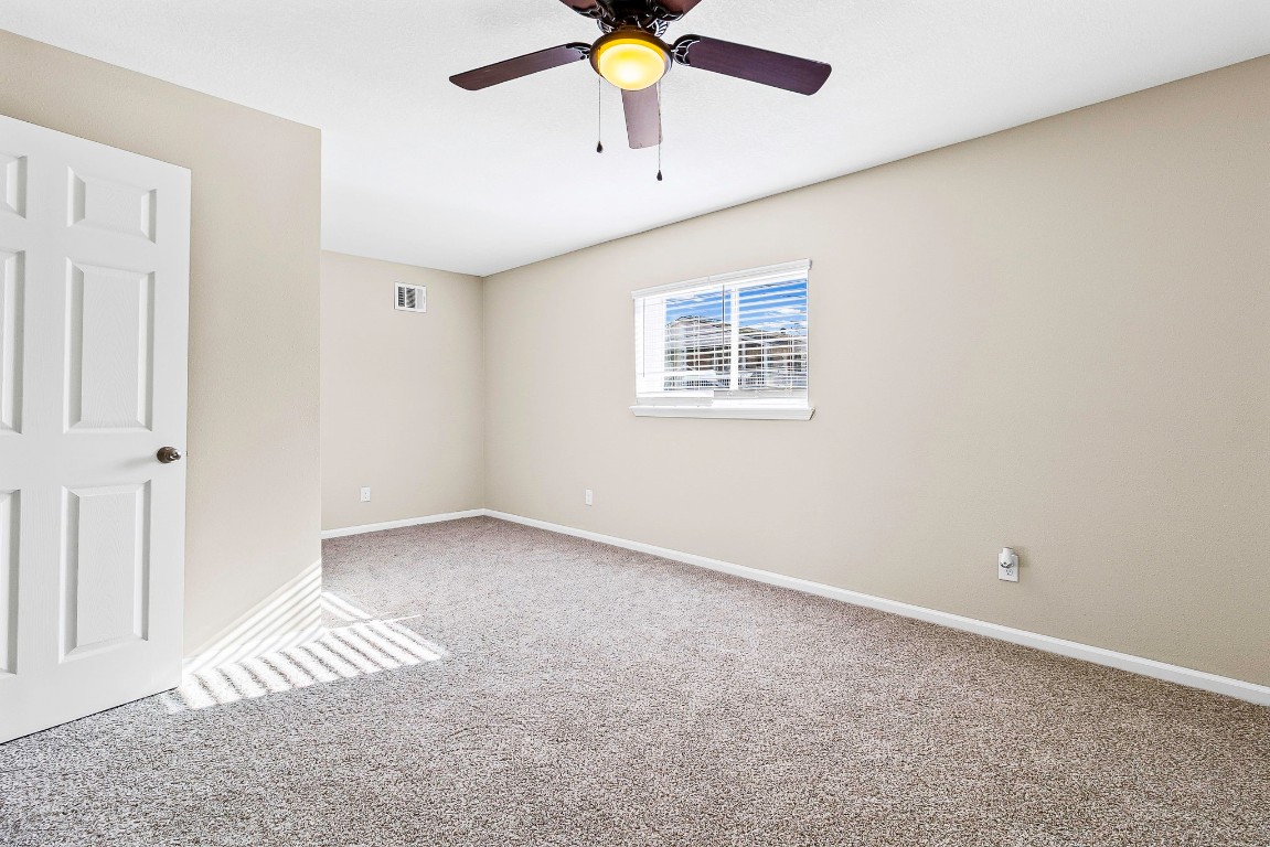 416 Kickapoo Drive Livingston, TX 77351 - Photo 29 of 36 an empty room with a window and a ceiling fan