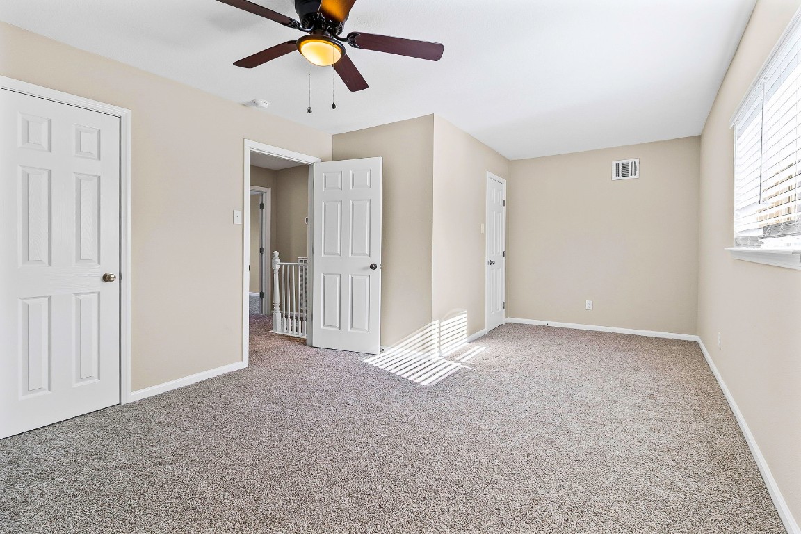 416 Kickapoo Drive Livingston, TX 77351 - Photo 30 of 36 a view of an empty room and window with a chandelier fan