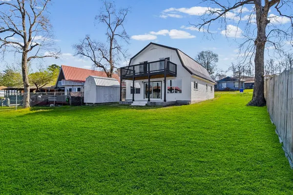 a view of a house with a big yard with large tree