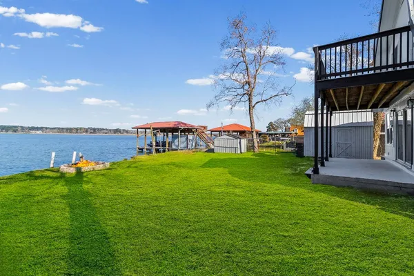 a view of a house with a big yard next to a yard