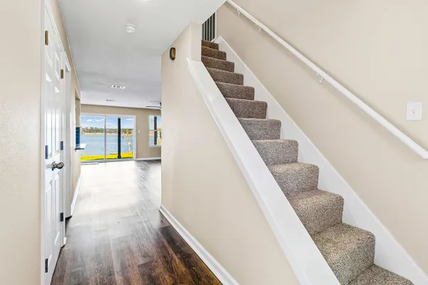 a view of entryway and hall with wooden floor