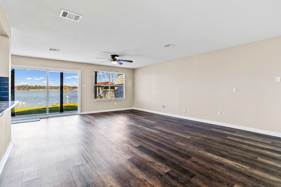 416 Kickapoo Drive Livingston, TX 77351 - Photo 8 of 36 an empty room with wooden floor and windows