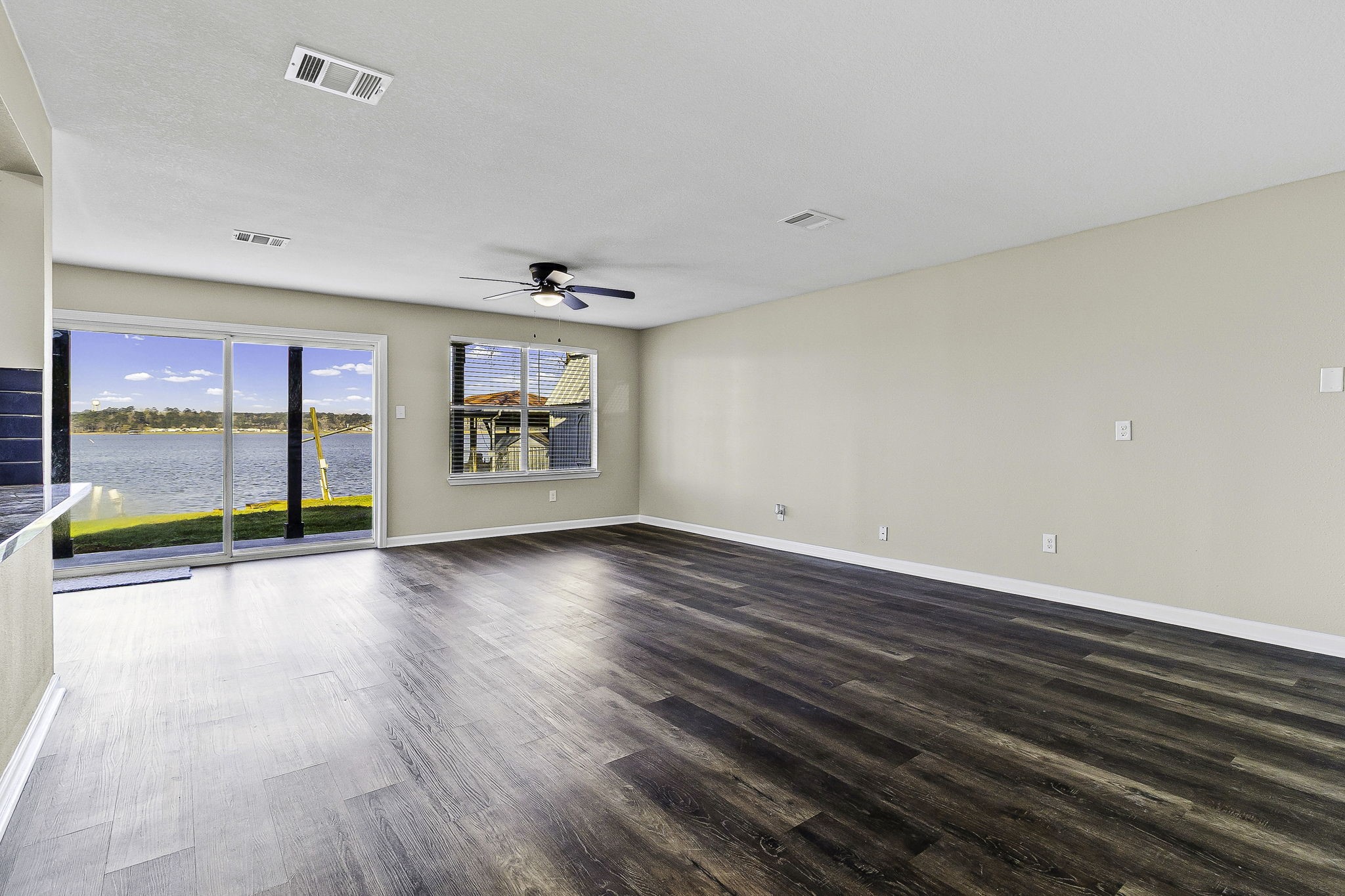 416 Kickapoo Drive Livingston, TX 77351 - Photo 8 of 36 wooden floor in an empty room with a window
