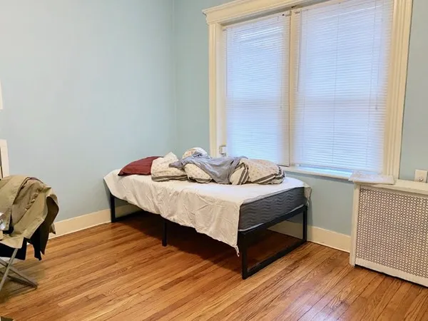 a bedroom with a bed and a chair