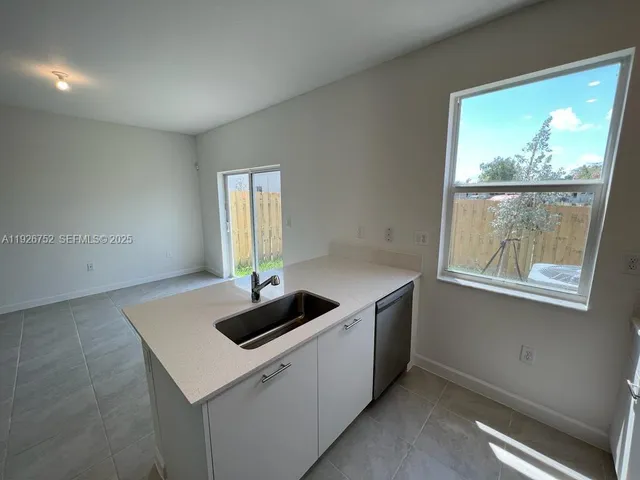a kitchen with a sink and a window