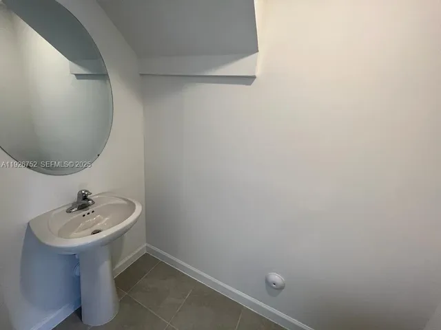 a bathroom with a sink and mirror