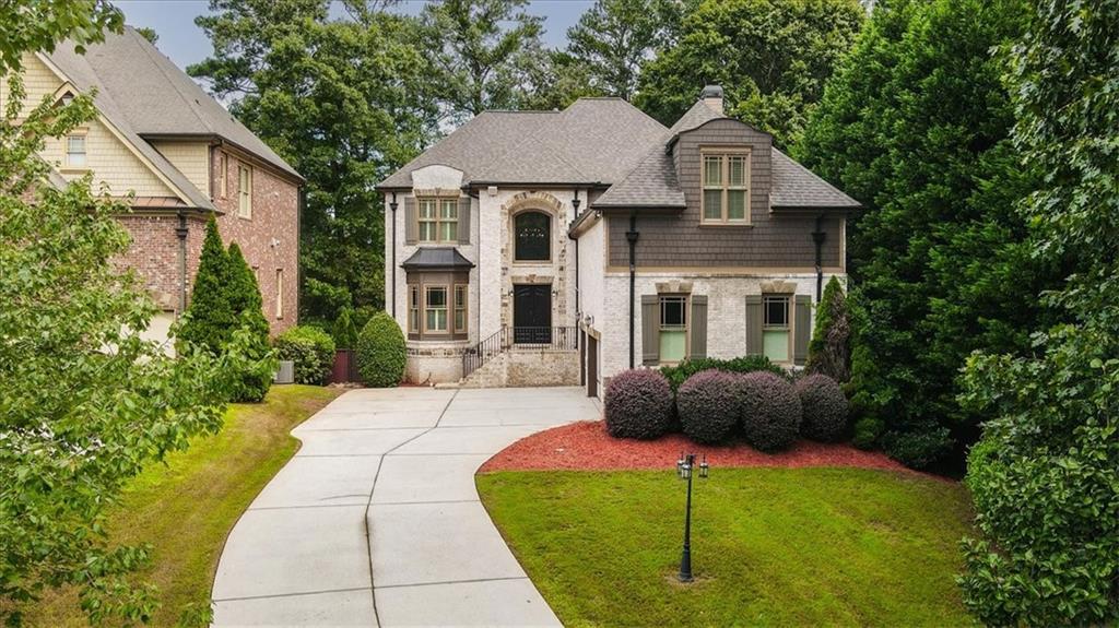 a front view of a house with a yard and porch