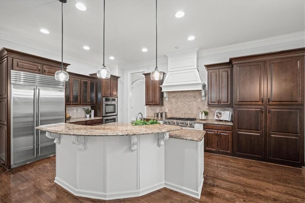 3594 North Druid Hills Road Decatur, GA 30033 - Photo 11 of 57 a kitchen with kitchen island stainless steel appliances a sink and a refrigerator