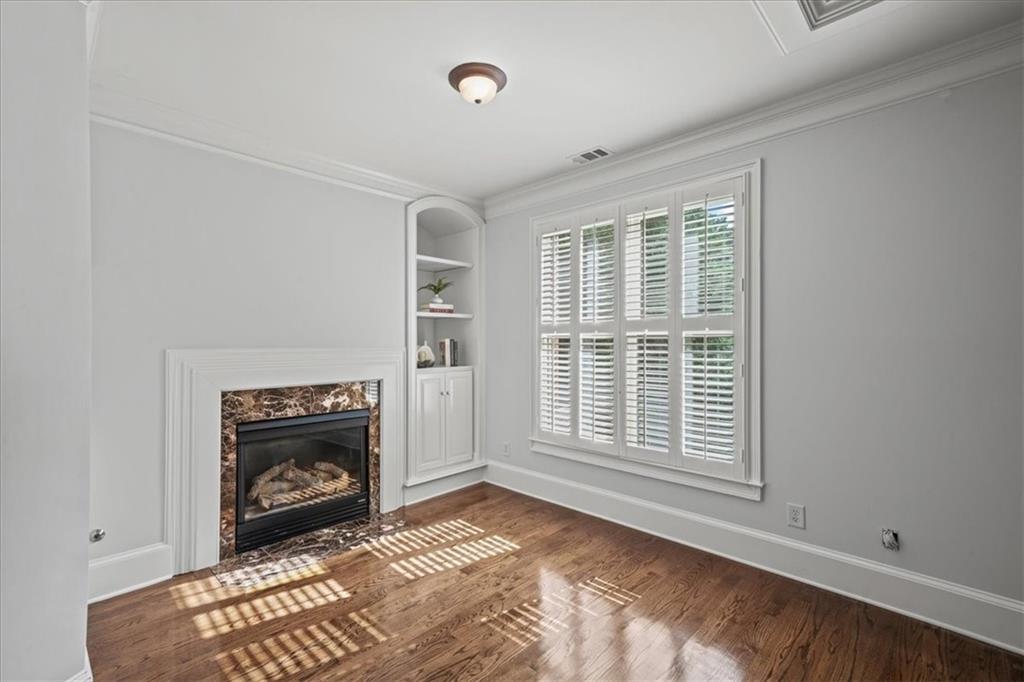 3594 North Druid Hills Road Decatur, GA 30033 - Photo 29 of 57 a view of an empty room with a fireplace and a window