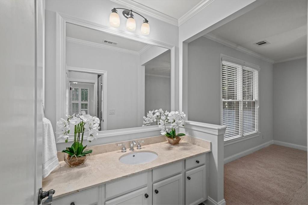 3594 North Druid Hills Road Decatur, GA 30033 - Photo 40 of 57 a bathroom with a granite countertop sink a mirror and a shower