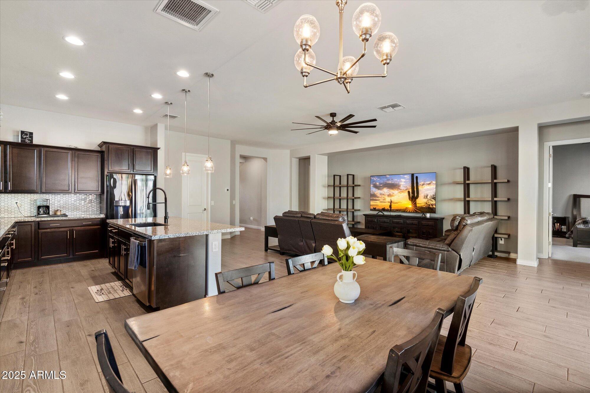 7424 West Jasmine Trail Peoria, AZ 85383 - Photo 11 of 30 a kitchen with kitchen island a dining table and chairs