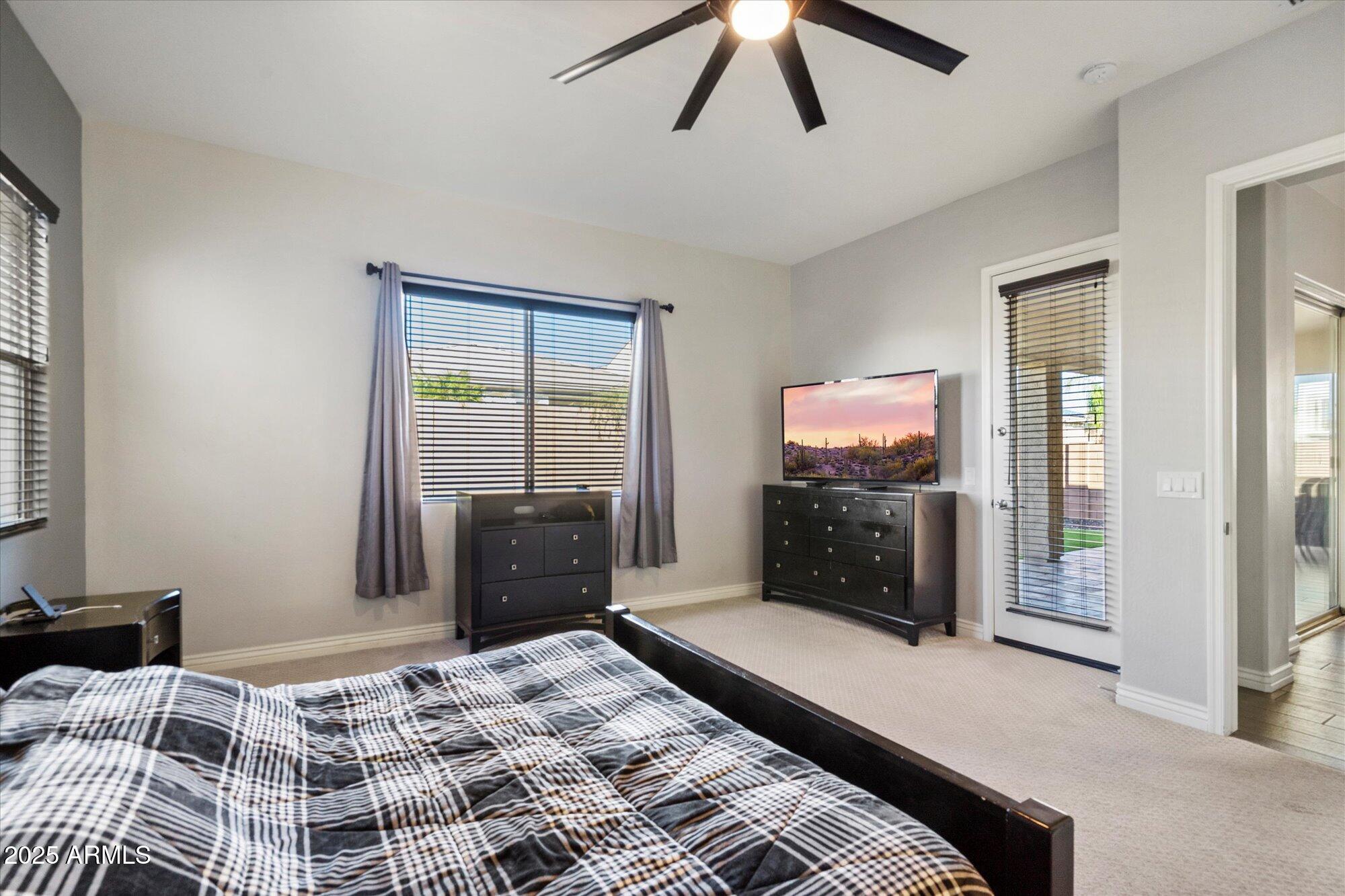 7424 West Jasmine Trail Peoria, AZ 85383 - Photo 13 of 30 a bedroom with a bed and a television