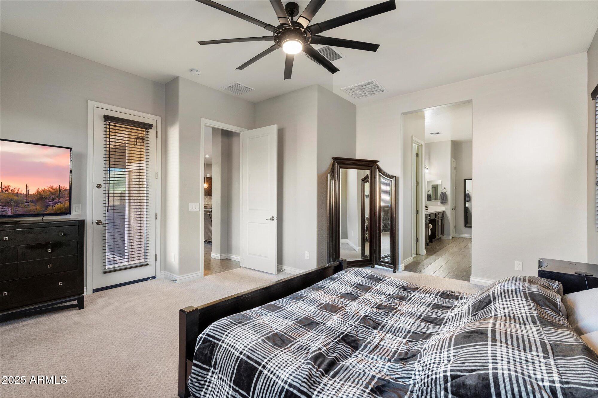 7424 West Jasmine Trail Peoria, AZ 85383 - Photo 14 of 30 a bedroom with a bed and a flat screen tv