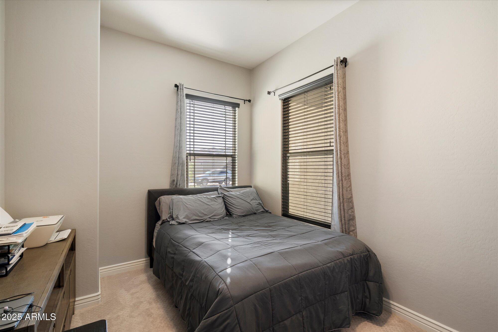 7424 West Jasmine Trail Peoria, AZ 85383 - Photo 17 of 30 a bedroom with a bed and a window