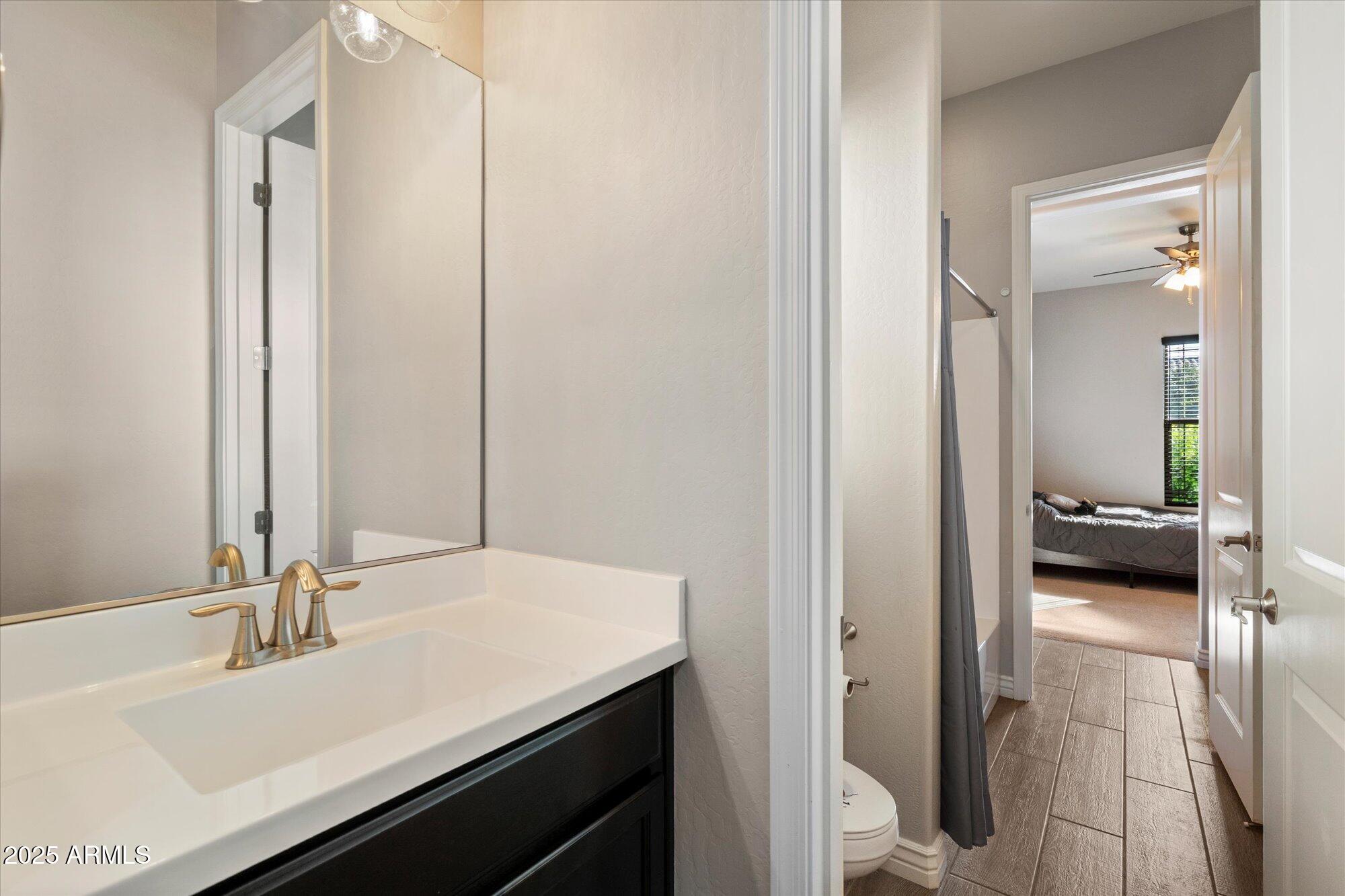 7424 West Jasmine Trail Peoria, AZ 85383 - Photo 18 of 30 a en suite bathroom with a sink and a mirror