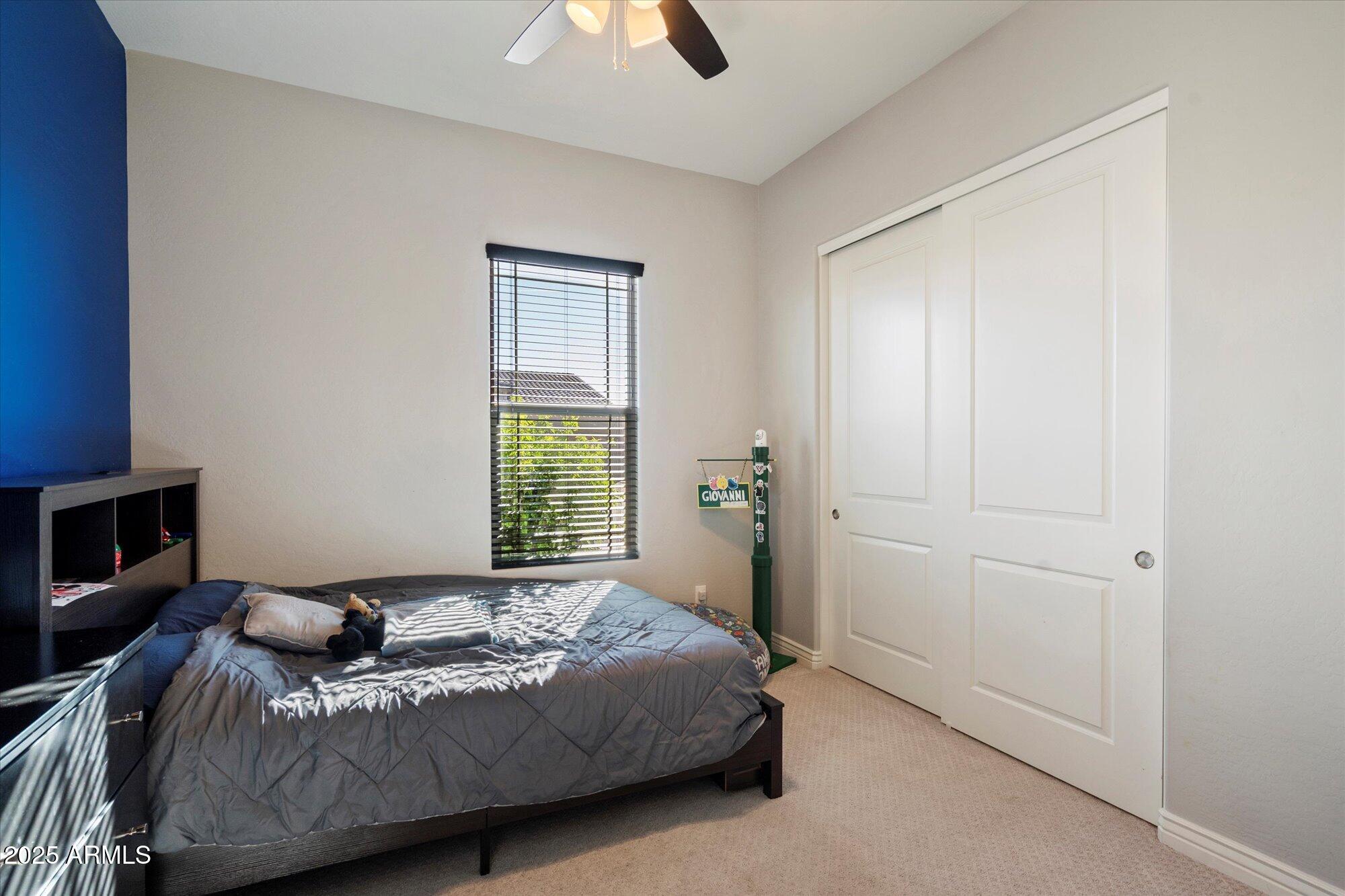 7424 West Jasmine Trail Peoria, AZ 85383 - Photo 19 of 30 a bedroom with a bed and a window