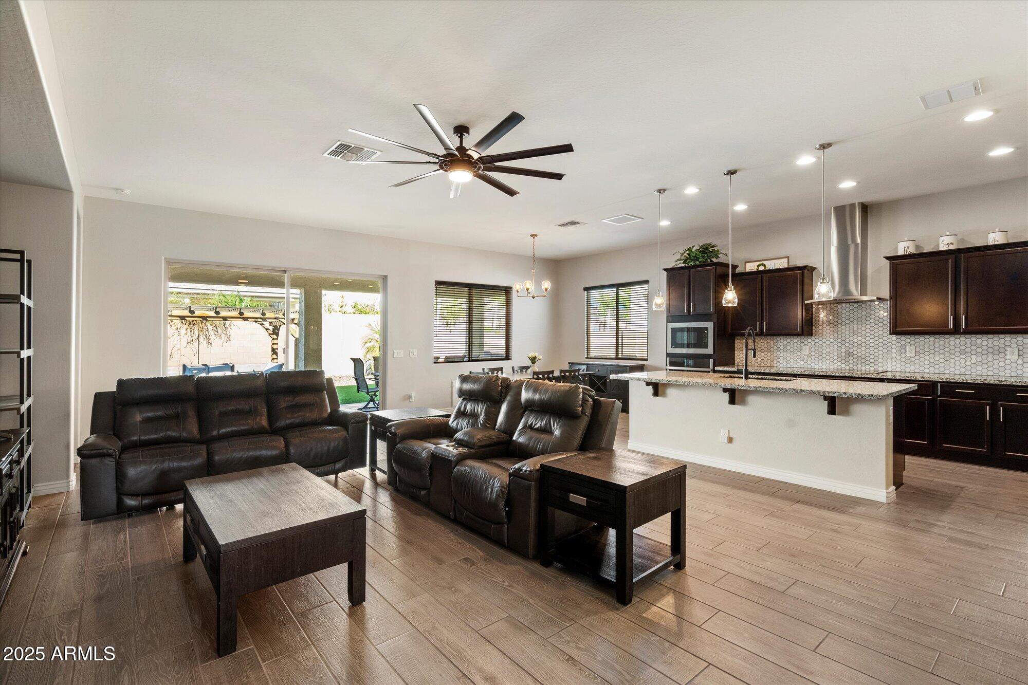 7424 West Jasmine Trail Peoria, AZ 85383 - Photo 2 of 30 a living room with furniture and a wooden floor
