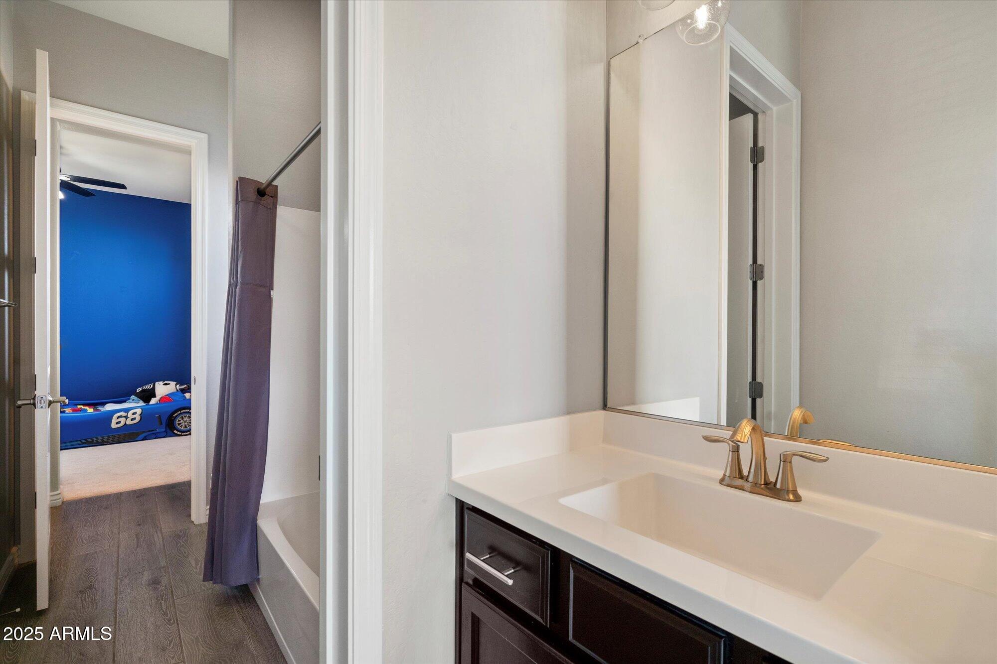 7424 West Jasmine Trail Peoria, AZ 85383 - Photo 21 of 30 a bathroom with a sink and a mirror