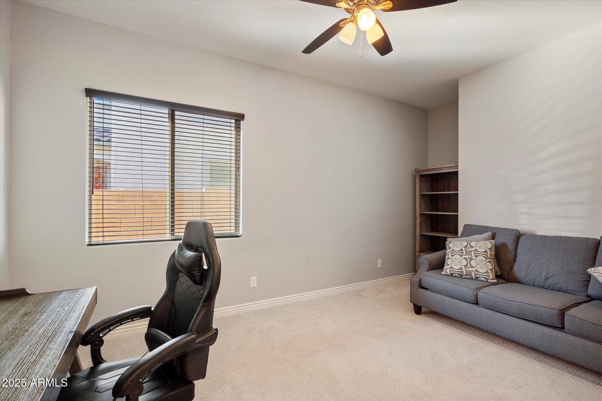 7424 West Jasmine Trail Peoria, AZ 85383 - Photo 22 of 30 a living room with furniture and a window