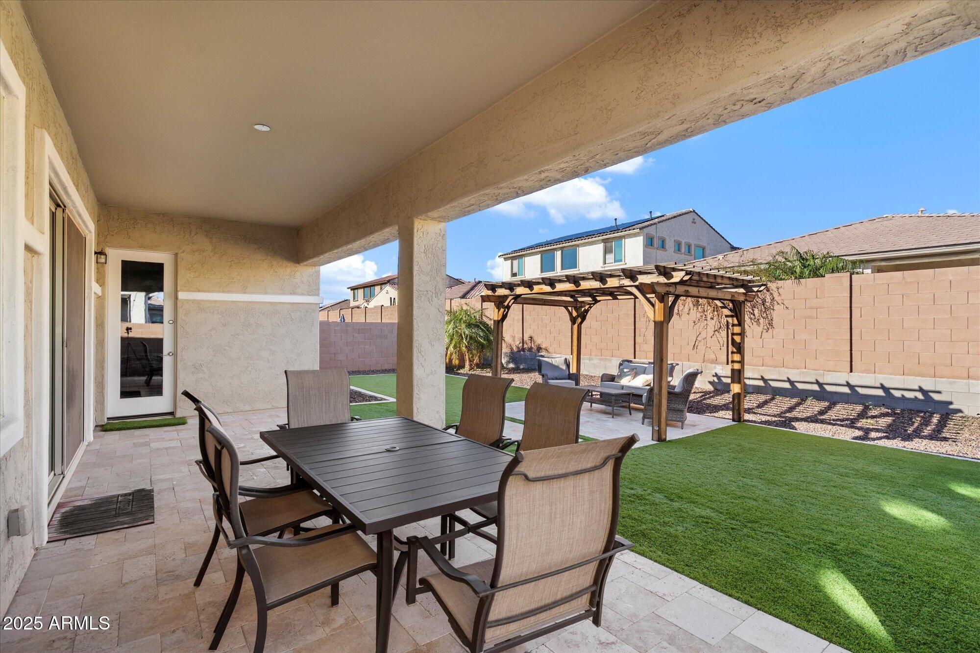 7424 West Jasmine Trail Peoria, AZ 85383 - Photo 25 of 30 a view of a patio with table and chairs and potted plants