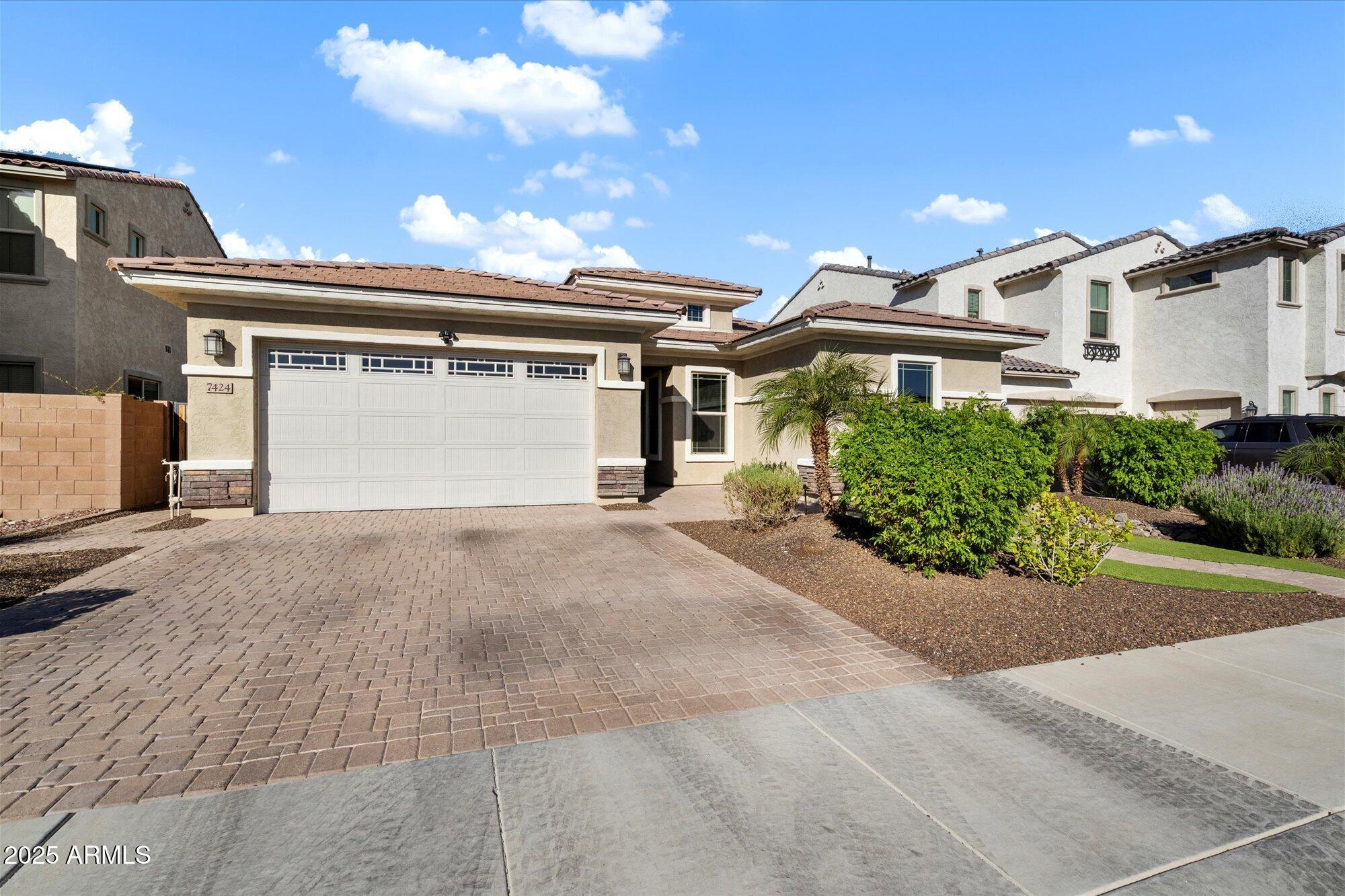 7424 West Jasmine Trail Peoria, AZ 85383 - Photo 30 of 30 a front view of a house with a yard and garage