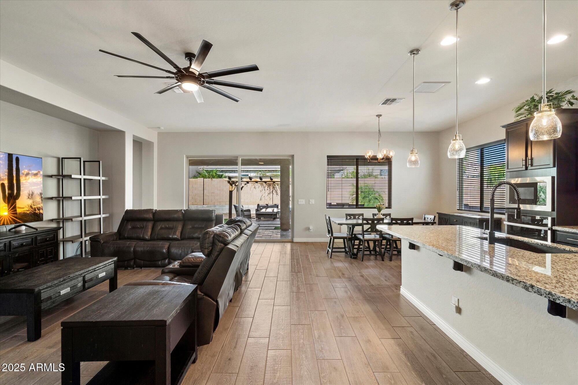 7424 West Jasmine Trail Peoria, AZ 85383 - Photo 3 of 30 a living room with furniture and a wooden floor