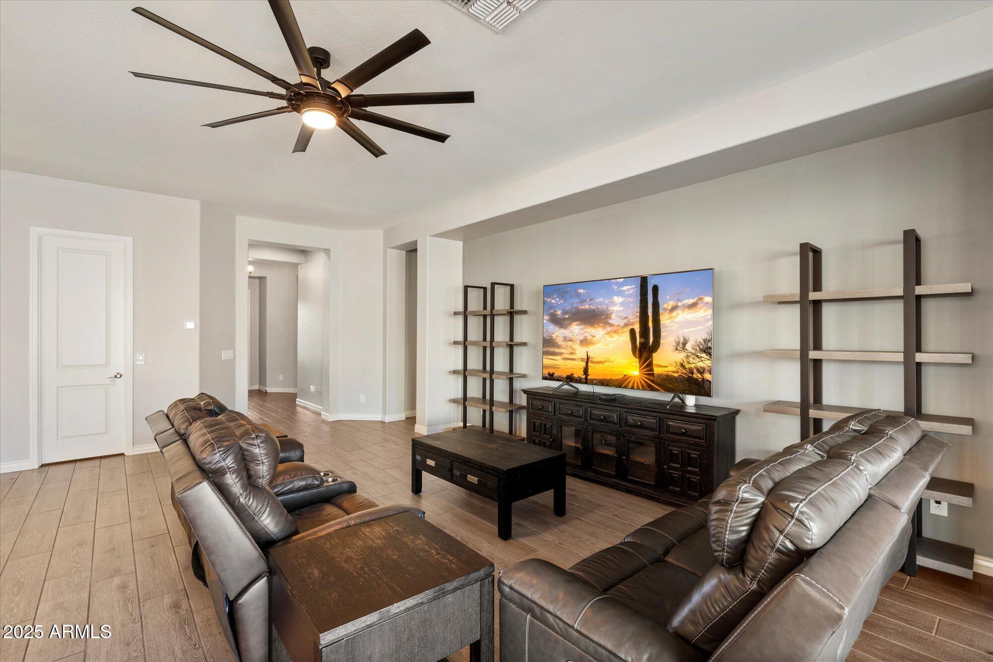 7424 West Jasmine Trail Peoria, AZ 85383 - Photo 4 of 30 a living room with furniture and a flat screen tv