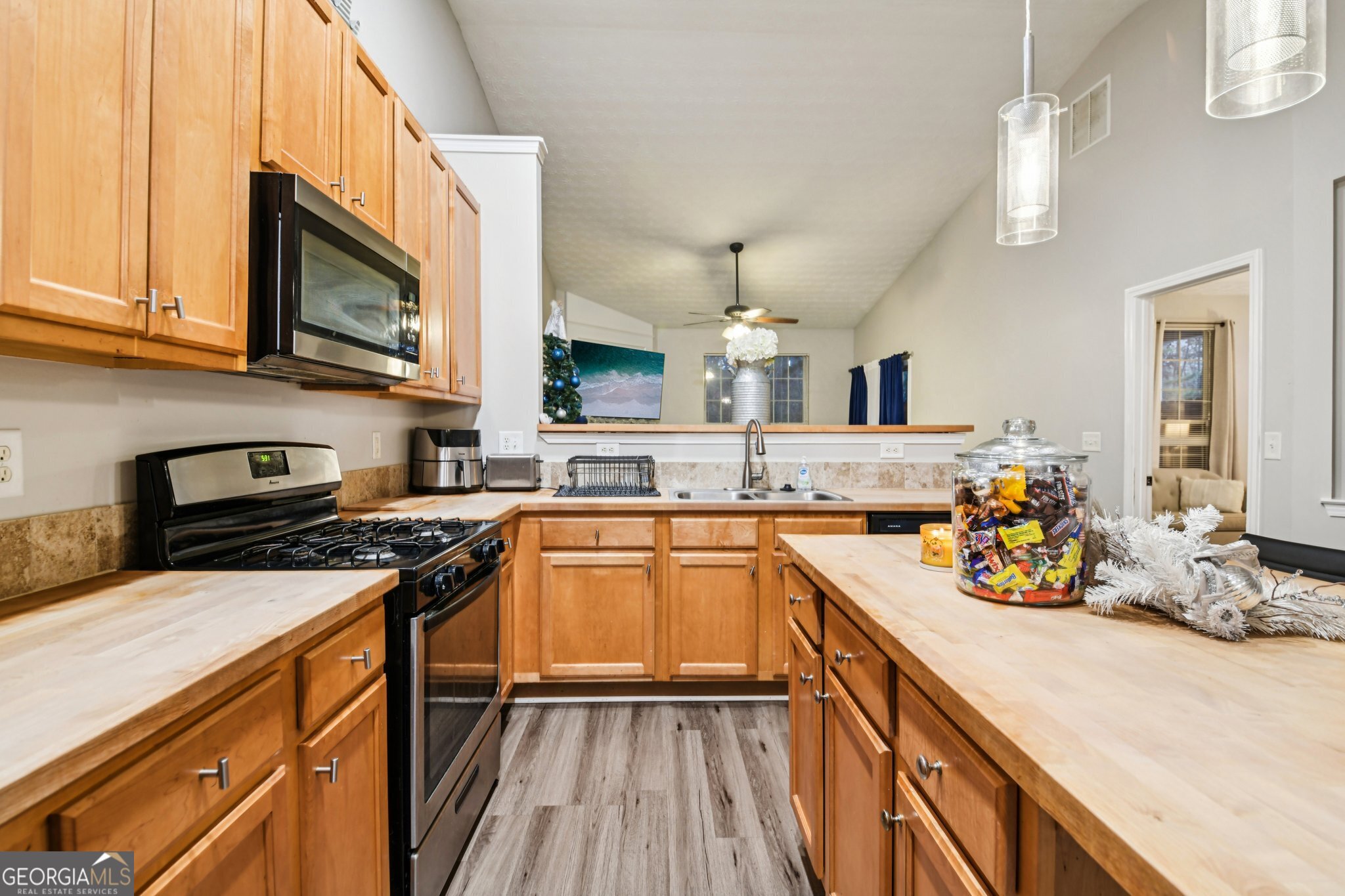 564 Goldfinch Way Stockbridge, GA 30281 - Photo 12 of 31 a kitchen with stainless steel appliances a sink stove and cabinets