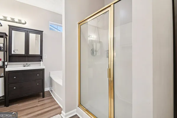 a bathroom with a sink a mirror and a shower